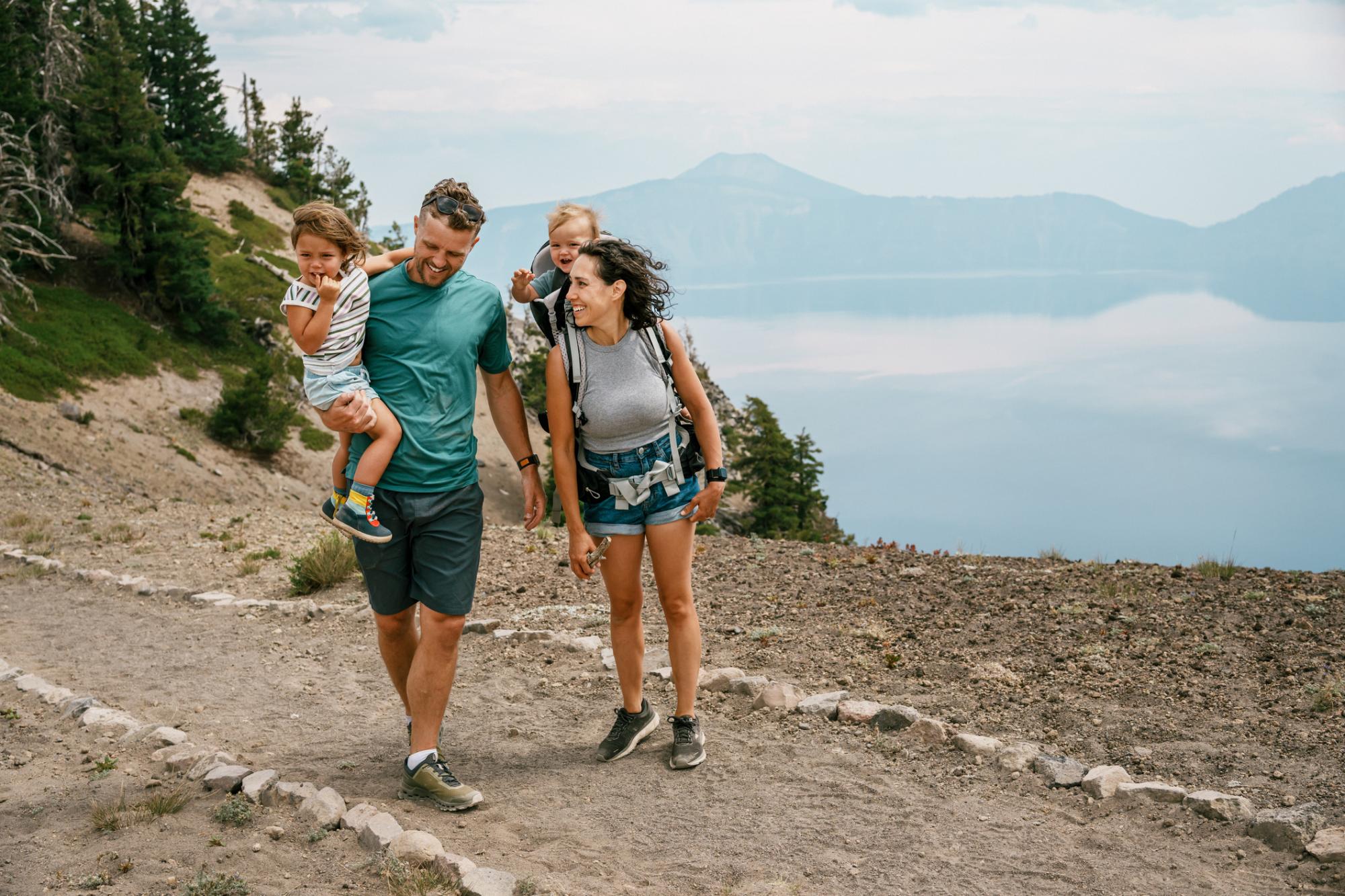 Fit multiracial couple with two young kids hiking